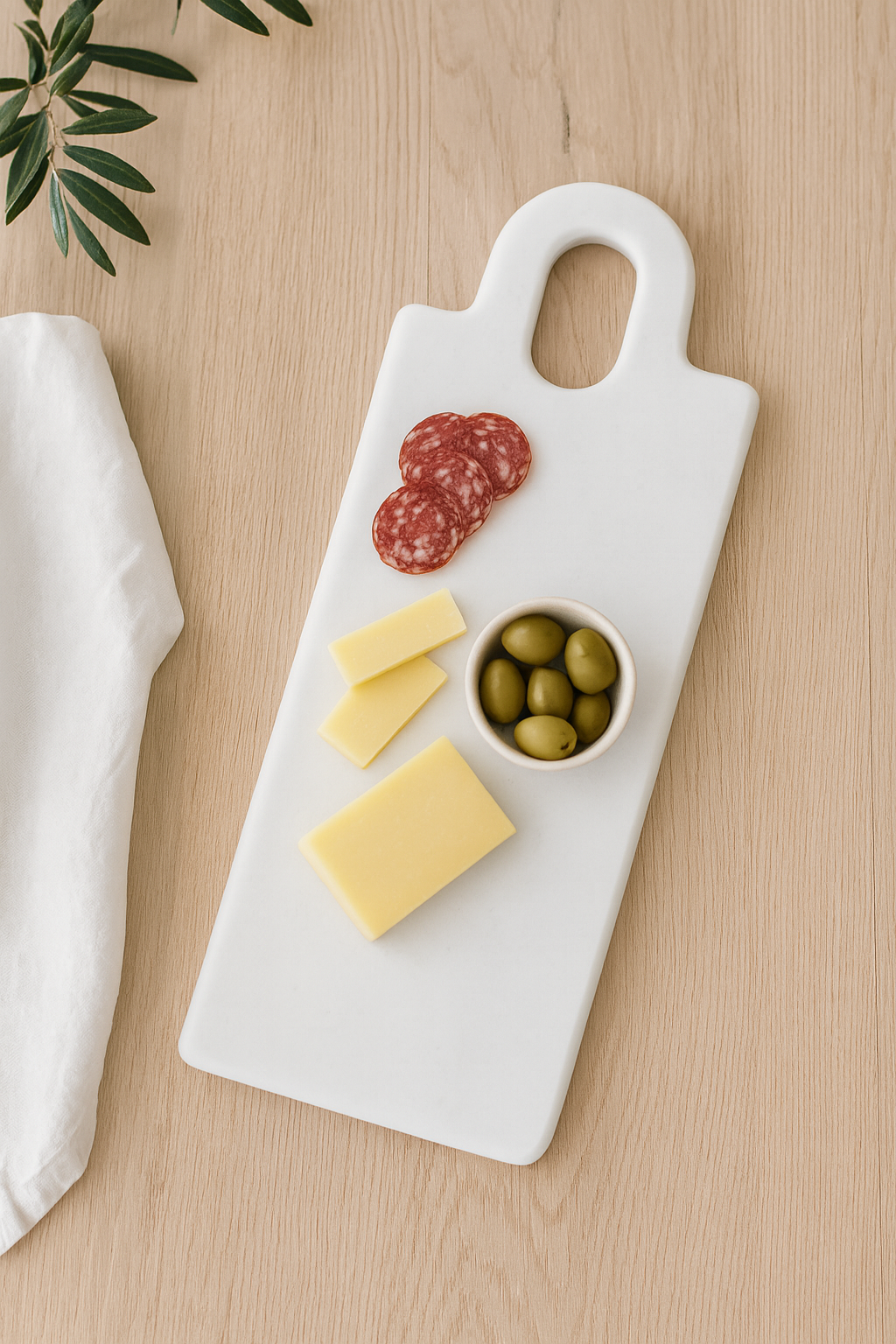 White marble cutting board with handle used for table serving and appetizers