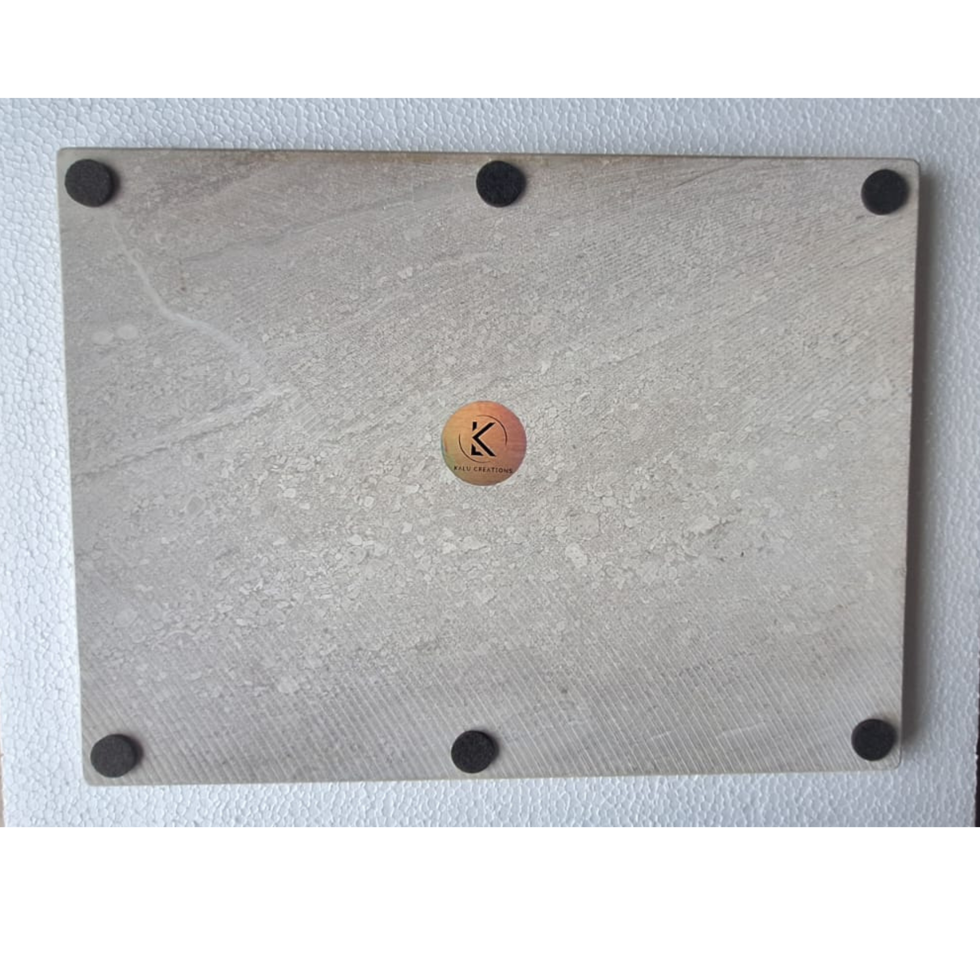 Back view of marble cutting board with protective feet