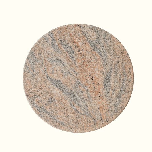 Round granite serving board with natural multicolor stone pattern, handcrafted in Italy